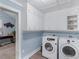 Laundry room with washer, dryer, and ample storage cabinets at 1202 Coan Dr, Locust Grove, GA 30248