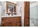 Bathroom vanity featuring a wooden vanity with white countertops and wooden framed mirror at 4288 Post Rd, Winston, GA 30187