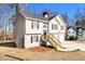 Two-story house with beige siding, attached garage, and wood stairs at 459 Pleasant Way, Temple, GA 30179