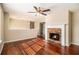 Living room with hardwood floors, fireplace, and ceiling fan at 459 Pleasant Way, Temple, GA 30179