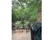 Outdoor patio with brick walls, iron fence and outdoor seating with shade trees at 323 The Chace Ne, Sandy Springs, GA 30328