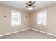 Simple bedroom with neutral walls, carpet, and two windows at 364 Stafford Sw St, Marietta, GA 30064