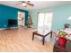 Spacious living area with teal and blue walls and laminate wood flooring at 364 Stafford Sw St, Marietta, GA 30064