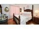 Elegant bedroom with a four-poster bed and hardwood floors at 405 Laurel Spring Ct, Canton, GA 30114