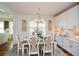 Bright dining room features a rustic table, chandelier, and built-in cabinetry at 405 Laurel Spring Ct, Canton, GA 30114