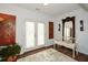 Bright entryway with french doors, hardwood floors, and decorative wall art at 405 Laurel Spring Ct, Canton, GA 30114