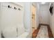 Welcoming entryway with a white bench, hooks, and hardwood floors at 405 Laurel Spring Ct, Canton, GA 30114