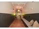 Building hallway with dark wainscoting, hardwood floors, and a built-in bench at 405 Laurel Spring Ct, Canton, GA 30114