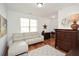 Bright home office features hardwood floors, built-in desk, and comfortable seating at 405 Laurel Spring Ct, Canton, GA 30114