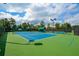 Well-lit tennis courts with green surface and fencing at 405 Laurel Spring Ct, Canton, GA 30114