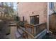 Back exterior view with brick facade, small patio, and fenced yard at 4116 River Cliff Chase Se, Marietta, GA 30067