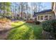 Well-manicured backyard featuring a lush lawn, mature trees, and a wooden deck off the rear of the house at 4116 River Cliff Chase Se, Marietta, GA 30067