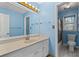 Blue bathroom featuring a single vanity with a stone countertop, and a shower-tub combo at 4116 River Cliff Chase Se, Marietta, GA 30067
