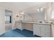 Bright bathroom featuring blue tile floors, double sink vanity with granite countertop, and connecting bedroom at 4116 River Cliff Chase Se, Marietta, GA 30067