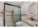 Bathroom featuring a tiled shower with sliding glass doors, modern fixtures, and a granite-topped vanity at 4116 River Cliff Chase Se, Marietta, GA 30067