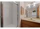 Bathroom featuring a shower with glass door, vanity with light wood cabinets, and a large mirror at 4116 River Cliff Chase Se, Marietta, GA 30067