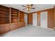This bedroom features wood paneling, built-in shelving, and plush carpeting, perfect for a cozy retreat at 4116 River Cliff Chase Se, Marietta, GA 30067