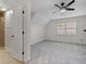 Gray carpeted bedroom with ceiling fan and bathroom access, illuminated by natural light from a window at 4116 River Cliff Chase Se, Marietta, GA 30067