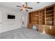 Cozy bedroom features a ceiling fan, plush gray carpet, and a built-in bookcase with desk at 4116 River Cliff Chase Se, Marietta, GA 30067