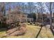 A beautiful two-story brick home nestled in a wooded neighborhood, featuring a well-manicured front yard at 4116 River Cliff Chase Se, Marietta, GA 30067