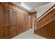 Hallway with wood paneling, built-in storage, stairs, and tile floor at 4116 River Cliff Chase Se, Marietta, GA 30067