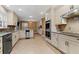 Well-lit kitchen features stainless steel appliances, granite countertops, and ample cabinet space at 4116 River Cliff Chase Se, Marietta, GA 30067