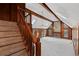 Staircase leading to a living room with vaulted ceiling, wood paneling, fireplace, and many windows at 4116 River Cliff Chase Se, Marietta, GA 30067