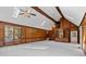Expansive living room with wood paneling, vaulted ceilings, stairs, and built-in bookshelves at 4116 River Cliff Chase Se, Marietta, GA 30067