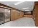 Room with wood paneling and built-in bookcases, cabinets and sliding glass door at 4116 River Cliff Chase Se, Marietta, GA 30067