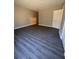 A large room with grey wood-look floors at 801 Hemingway Rd, Stone Mountain, GA 30088