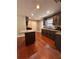 Spacious kitchen with stainless steel sink, dark wood cabinets and a view to the backdoor at 801 Hemingway Rd, Stone Mountain, GA 30088