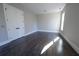 Cozy bedroom with modern doors, ample natural light streaming through a large window, and sleek dark hardwood flooring at 4238 Paces Ferry Se Rd, Atlanta, GA 30339