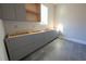 Bright kitchen with gray cabinets and gray tile flooring; in need of countertops and appliances at 4238 Paces Ferry Se Rd, Atlanta, GA 30339