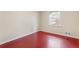 Bedroom with red painted floors and window at 4334 Greenleaf Sw Cir, Atlanta, GA 30331
