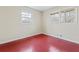 Simple bedroom with red painted floors and neutral walls at 4334 Greenleaf Sw Cir, Atlanta, GA 30331