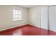 Bedroom with red floors and white closet doors at 4334 Greenleaf Sw Cir, Atlanta, GA 30331