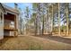 Backyard with wooded views, grass and a stone patio at 101 Forsyth Park Ln, Woodstock, GA 30188