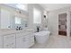 Bright bathroom featuring double vanities with quartz countertops, freestanding tub, and black fixtures at 101 Forsyth Park Ln, Woodstock, GA 30188
