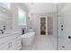 Bright bathroom with a freestanding tub, double vanities, glass enclosed shower and access to a walk-in closet at 101 Forsyth Park Ln, Woodstock, GA 30188