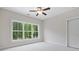 Sun-filled bedroom featuring a large window and neutral carpeting at 101 Forsyth Park Ln, Woodstock, GA 30188