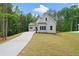 Stylish new home features a concrete driveway, manicured lawn and an eye-catching neutral color palette at 101 Forsyth Park Ln, Woodstock, GA 30188