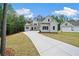 Newly constructed white two-story home features manicured lawn and a long concrete driveway at 101 Forsyth Park Ln, Woodstock, GA 30188