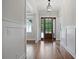 Inviting foyer with hardwood floors, wood trim, paneled walls, and a wooden front door with sidelights at 101 Forsyth Park Ln, Woodstock, GA 30188