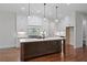 Modern gourmet kitchen with an oversized center island, modern appliances, and ample cabinet space at 101 Forsyth Park Ln, Woodstock, GA 30188