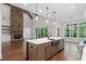 Spacious kitchen with a stone fireplace, stainless steel appliances, and a large center island at 101 Forsyth Park Ln, Woodstock, GA 30188