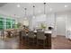 Modern kitchen with white cabinets, stainless steel appliances, a center island with seating, and an adjacent dining area at 101 Forsyth Park Ln, Woodstock, GA 30188
