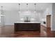 Modern gourmet kitchen with large center island, pendant lights, and a built in oven at 101 Forsyth Park Ln, Woodstock, GA 30188