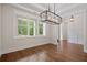 Bright room features hardwood floors, large windows offering views of the surrounding trees, and modern lighting at 101 Forsyth Park Ln, Woodstock, GA 30188