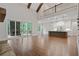 Bright living room features a soaring ceiling, wood beams, and access to the outdoor fireplace and modern gourmet kitchen at 101 Forsyth Park Ln, Woodstock, GA 30188
