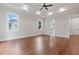 Sunlit main bedroom featuring hardwood floors, tray ceiling, and ensuite bathroom at 101 Forsyth Park Ln, Woodstock, GA 30188